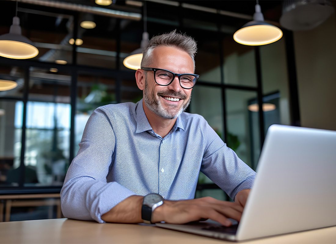 RV Insurance Quote Request - Middle Aged Business Man Working on His Laptop at the Office